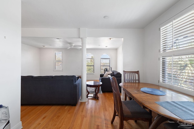 dining area with light wood-style floors and ceiling fan