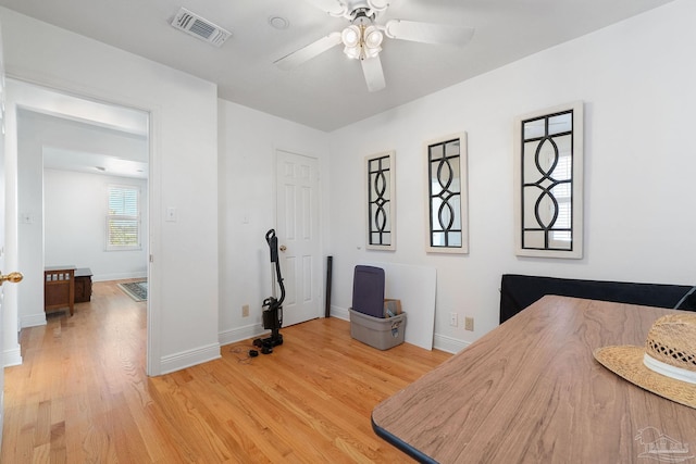 bedroom with light wood finished floors, baseboards, visible vents, and a ceiling fan