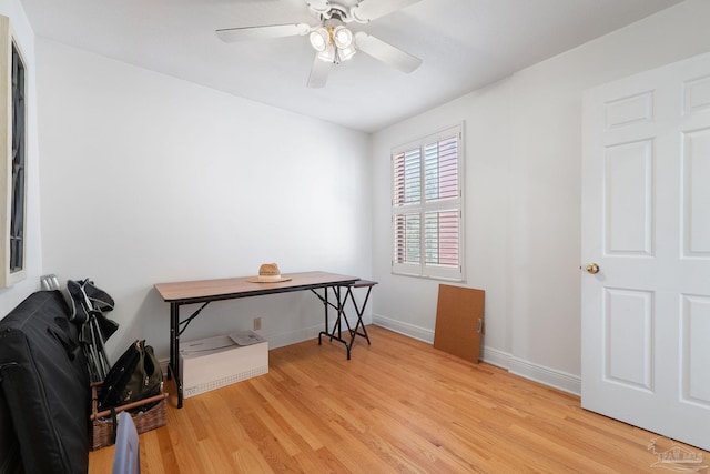 office space featuring baseboards, wood finished floors, and ceiling fan
