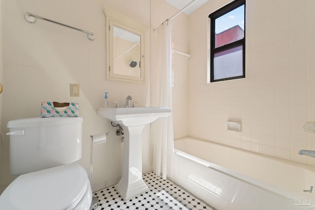 bathroom featuring toilet and shower / bathtub combination with curtain