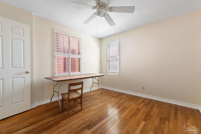 office featuring baseboards, wood finished floors, and ceiling fan