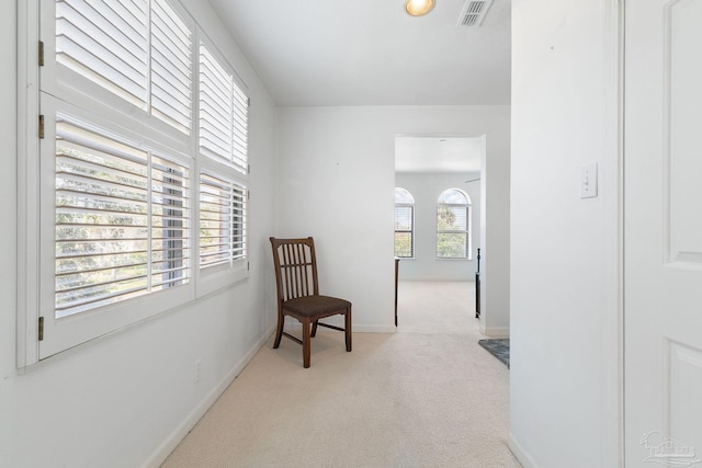 sitting room featuring baseboards, visible vents, and carpet floors