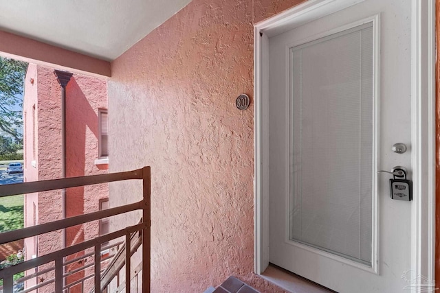 property entrance featuring stucco siding