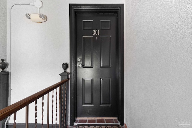 entrance to property with stucco siding