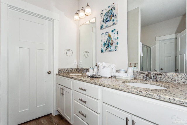 bathroom featuring an enclosed shower, hardwood / wood-style flooring, and vanity