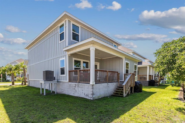 back of property with cooling unit, a yard, and a wooden deck