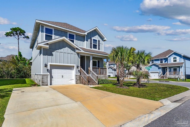 view of front of house featuring a front lawn, a porch, and a garage