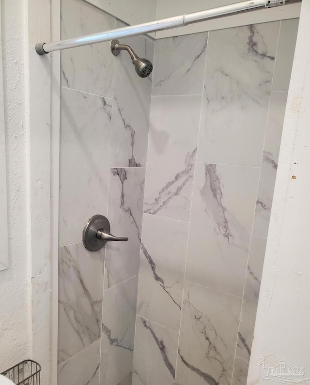bathroom with a tile shower