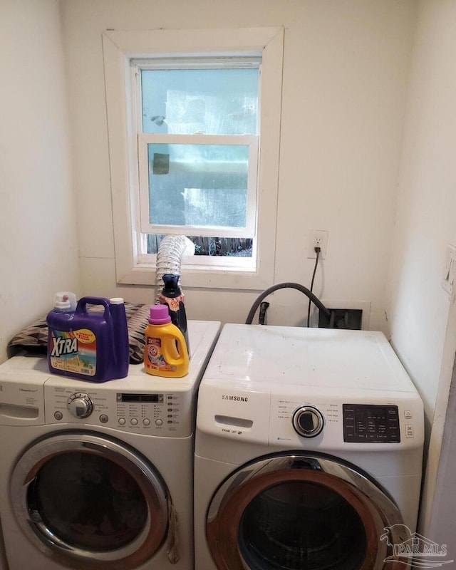 clothes washing area featuring laundry area and washer and dryer