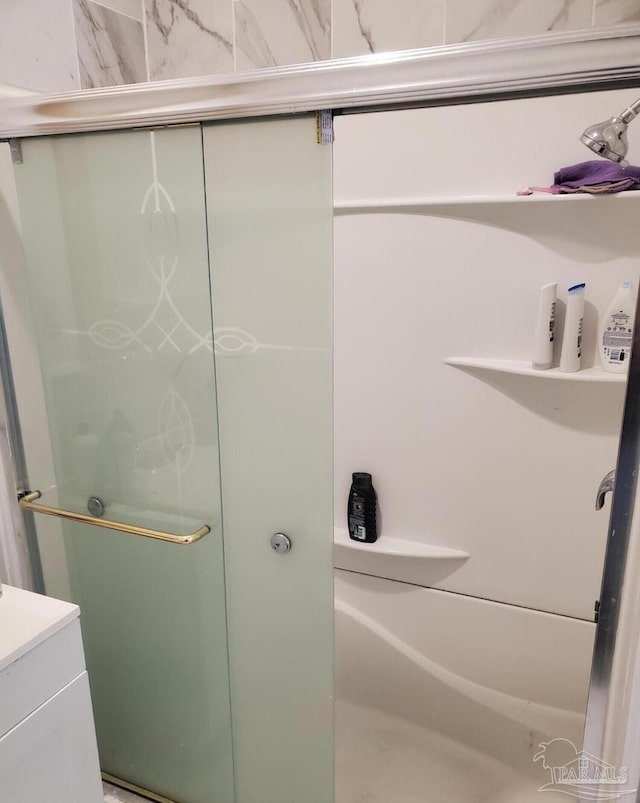 bathroom with a stall shower and vanity