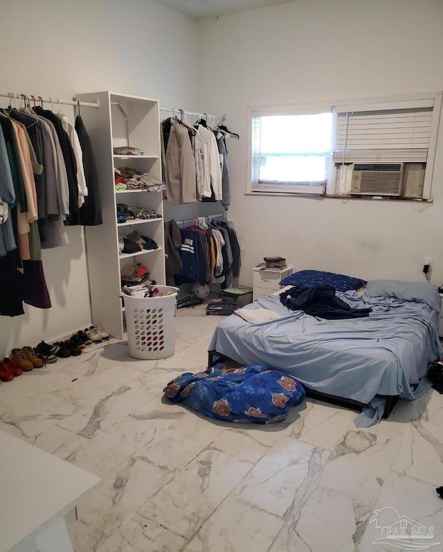 bedroom featuring marble finish floor and cooling unit