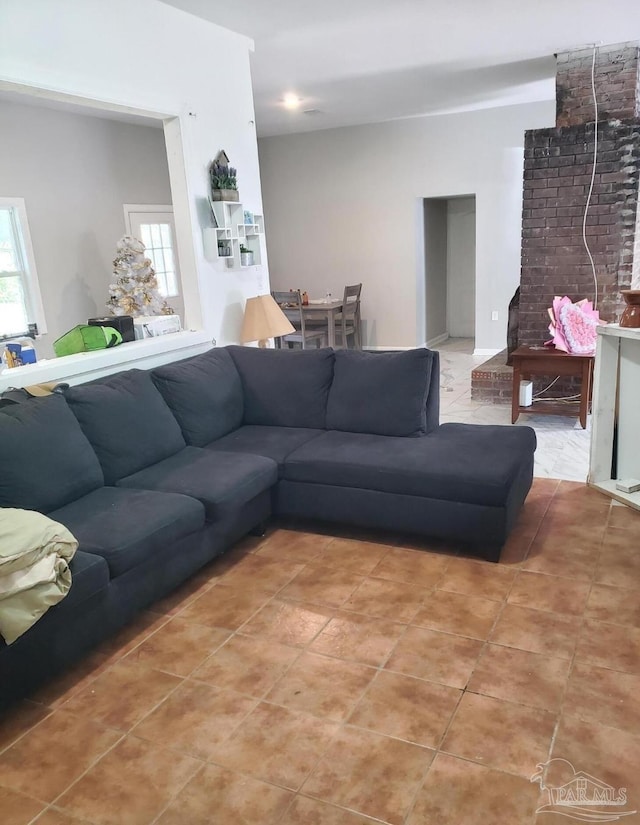 living room with a healthy amount of sunlight and light tile patterned floors