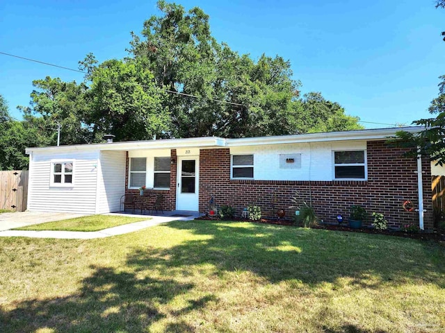 single story home featuring brick siding and a front lawn