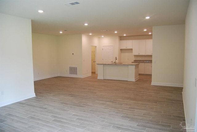 4702 Sago Palm Cir, Pace, FL 32571 - unfurnished living room with a sink, light wood finished floors, recessed lighting, and baseboards
