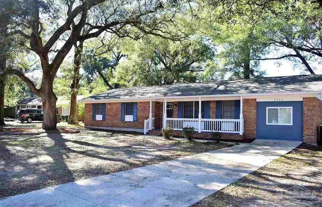 single story home with brick siding and covered porch