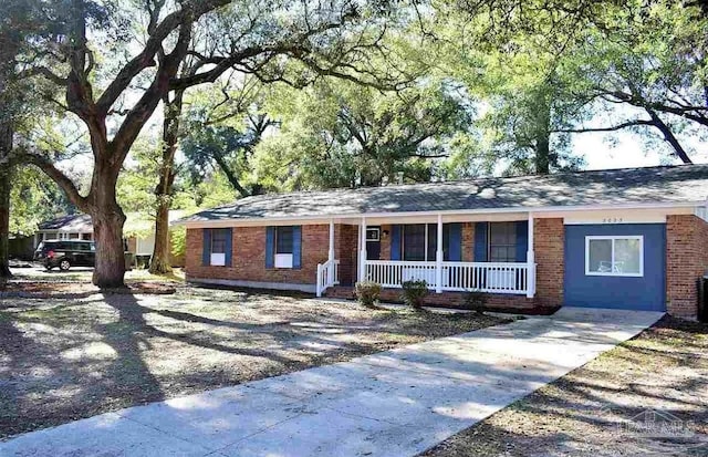 single story home with brick siding and covered porch