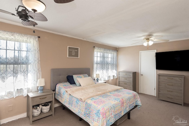 carpeted bedroom featuring ceiling fan and baseboards