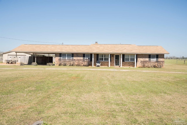 ranch-style house with a chimney, a front lawn, and brick siding