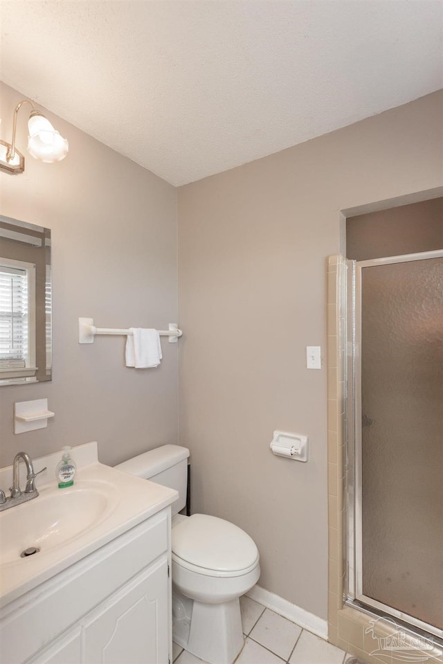 bathroom with vanity, a shower stall, toilet, and tile patterned floors