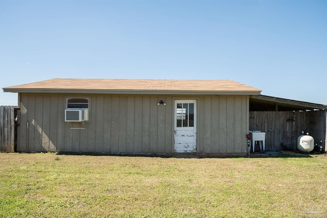 view of outbuilding with cooling unit and fence