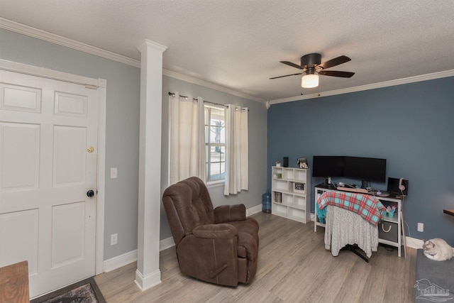 bedroom featuring ornamental molding, decorative columns, a textured ceiling, and wood finished floors