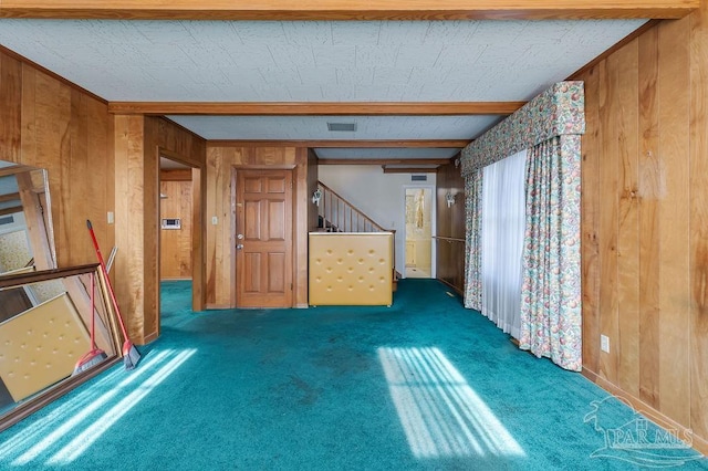 interior space with carpet and wooden walls