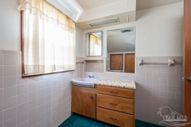 bathroom with vanity, backsplash, and tile walls