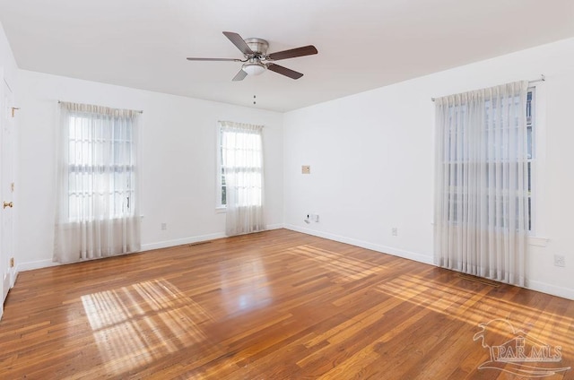 unfurnished room with ceiling fan and hardwood / wood-style flooring