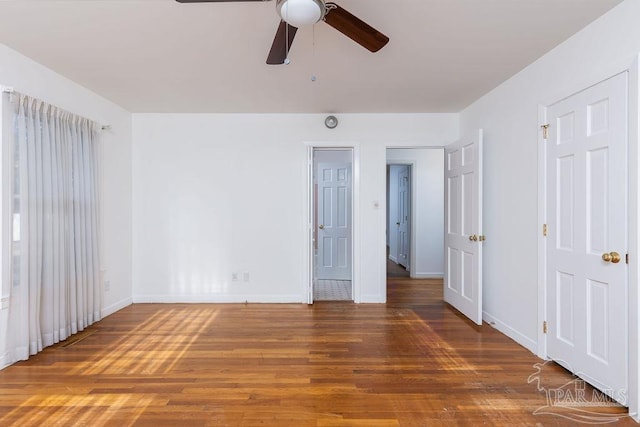 unfurnished bedroom with ceiling fan and wood-type flooring