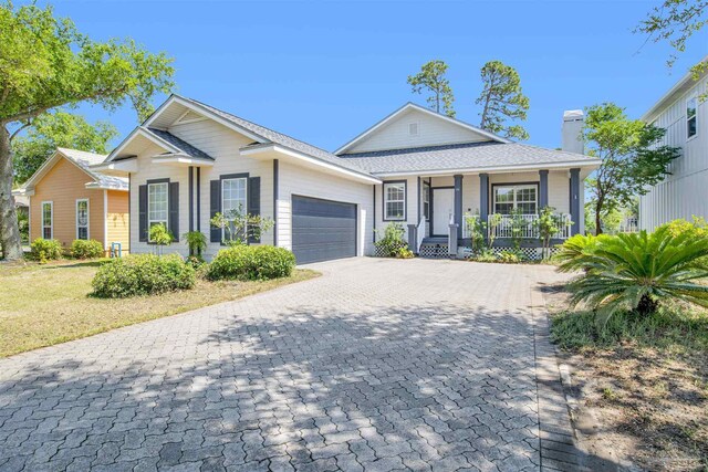 view of front of property with a porch and a garage