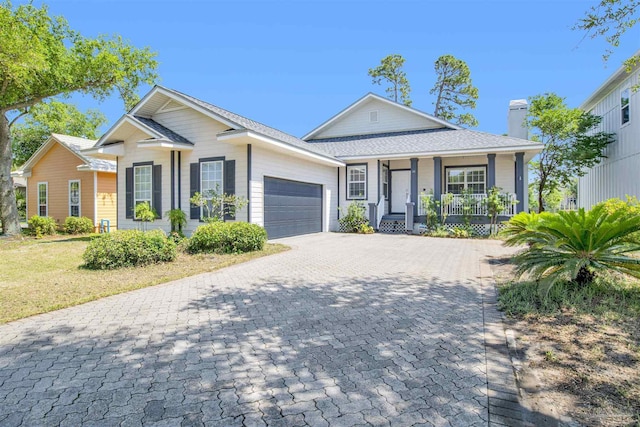 view of front of home featuring a porch and a garage