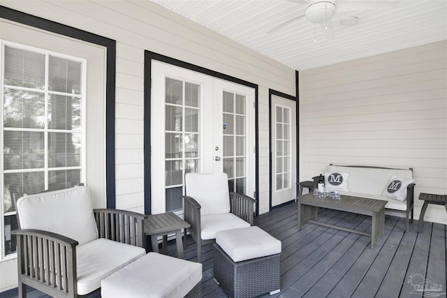 wooden deck with an outdoor hangout area, ceiling fan, and french doors