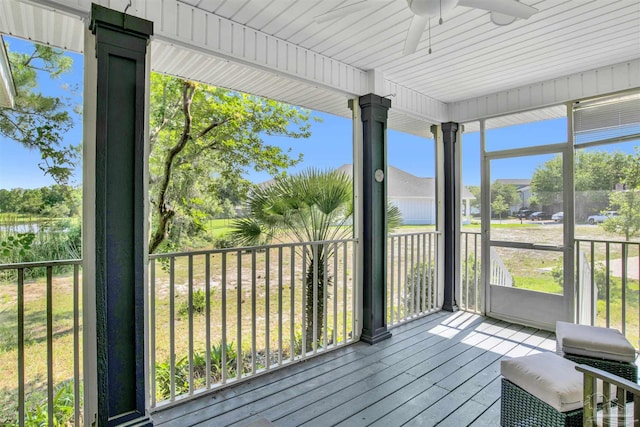 unfurnished sunroom featuring a wealth of natural light and ceiling fan