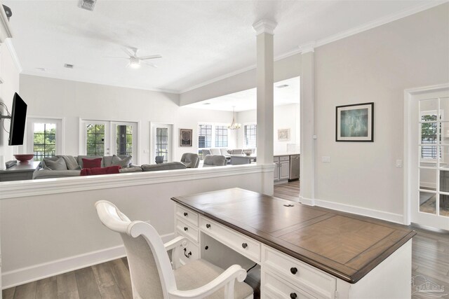 home office with decorative columns, french doors, dark hardwood / wood-style floors, ceiling fan, and ornamental molding