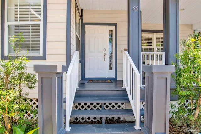 view of exterior entry with covered porch