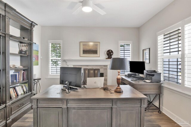 office with dark hardwood / wood-style floors and ceiling fan