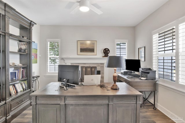 office area with plenty of natural light, dark hardwood / wood-style floors, and ceiling fan