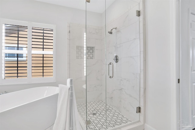 bathroom featuring independent shower and bath