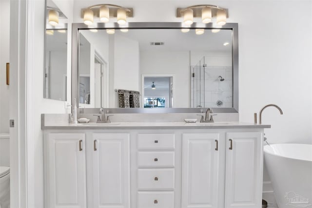 full bathroom featuring vanity, toilet, and separate shower and tub