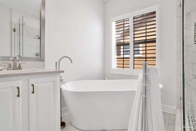 bathroom with vanity, tile patterned floors, and a washtub