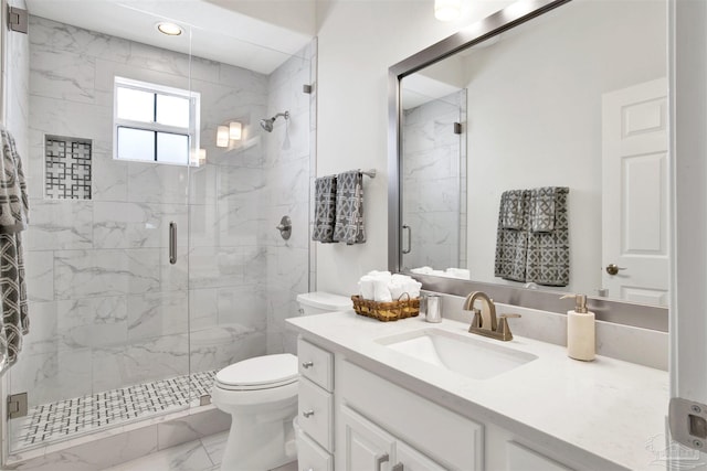 bathroom with vanity, an enclosed shower, and toilet