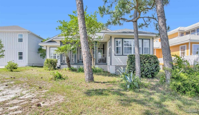 view of front of home with a porch and a front lawn