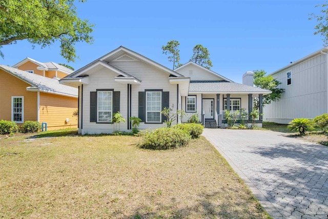 view of front of property with a front yard and a porch