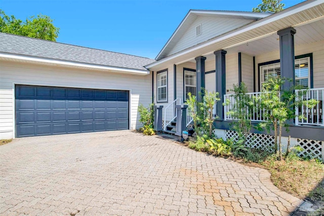 view of front of home with a garage and a porch