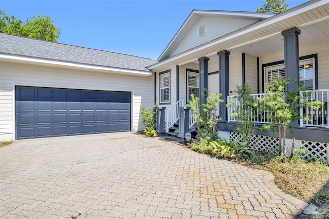 ranch-style house featuring a garage and covered porch