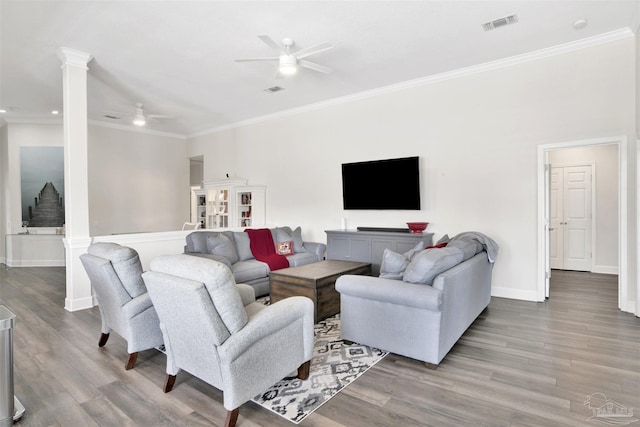 living room with ceiling fan, ornamental molding, decorative columns, and hardwood / wood-style floors