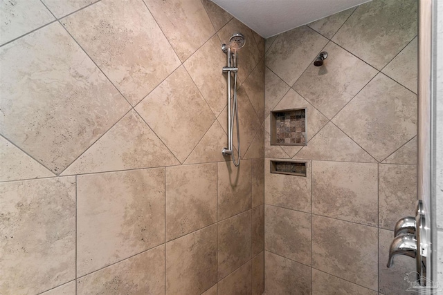 interior details with a tile shower