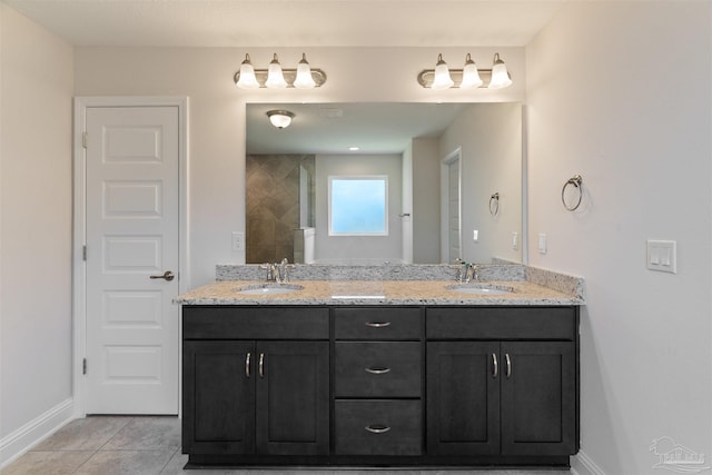 bathroom featuring a sink, double vanity, baseboards, and tile patterned flooring