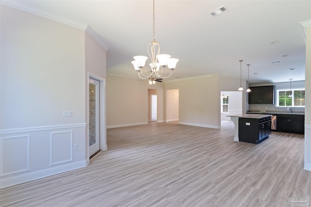 kitchen with a kitchen island, a notable chandelier, open floor plan, and visible vents