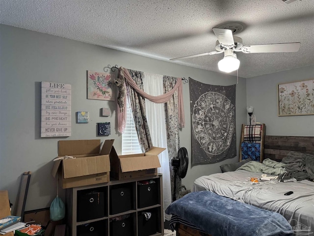 bedroom featuring a textured ceiling and a ceiling fan